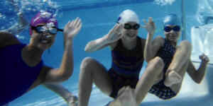 Team members swimming under water