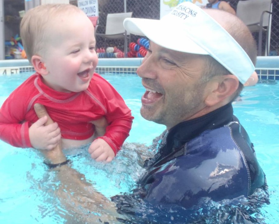 Parent in pool with tot